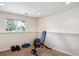 A cozy workout room with workout bench, weights, yoga mat, and natural light from the window at 9524 E Caley Cir, Englewood, CO 80111