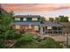 Inviting backyard with a fire pit, chairs, lush lawn, and a charming sunroom addition at 8732 W Arbor Ave, Littleton, CO 80123