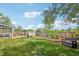 Well-maintained backyard with a lush lawn, shed, mature tree, and comfortable seating area at 8732 W Arbor Ave, Littleton, CO 80123