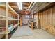 Unfinished basement with exposed ceiling, shelving, and workbench ready for customization at 8732 W Arbor Ave, Littleton, CO 80123