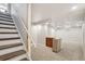 Finished basement featuring carpet flooring, bar, and stairs to main level at 8732 W Arbor Ave, Littleton, CO 80123