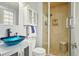 Bright bathroom with vessel sink, white cabinet, glass shower, and modern finishes at 8732 W Arbor Ave, Littleton, CO 80123