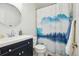 Bathroom featuring mountain landscape shower curtain, round mirror, and vanity sink at 8732 W Arbor Ave, Littleton, CO 80123