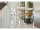Bright entryway with marble flooring, mirrored walls, and views of the living spaces at 8732 W Arbor Ave, Littleton, CO 80123