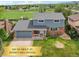 Charming two-story home features a brick facade, a well-manicured lawn, and an attached garage at 8732 W Arbor Ave, Littleton, CO 80123