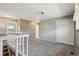 Upstairs landing with large closet, neutral paint, and a view of the living area below at 8732 W Arbor Ave, Littleton, CO 80123