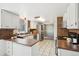 Modern kitchen with stainless steel appliances, brick accents, and ample countertop space at 8732 W Arbor Ave, Littleton, CO 80123