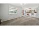 Open-concept living room with large window and mountain view connected to the kitchen area at 8732 W Arbor Ave, Littleton, CO 80123