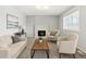 Comfortable living room featuring a charming fireplace, neutral decor, and an abundance of natural light at 8732 W Arbor Ave, Littleton, CO 80123