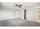 Neutral main bedroom featuring ceiling fan, sliding closet, and carpet flooring at 8732 W Arbor Ave, Littleton, CO 80123