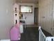 bedroom with a dollhouse, mirror, and neutral colored walls at 6850 E Archer Dr, Denver, CO 80230