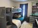 ' bedroom features a gray bunk bed, dark curtains and carpet, and ample storage at 6850 E Archer Dr, Denver, CO 80230