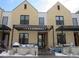 Inviting townhouse exterior with a pergola-covered porch and contemporary architectural details at 6850 E Archer Dr, Denver, CO 80230