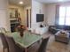 Open concept living space with a piano, guitar, comfortable seating, and a TV at 6850 E Archer Dr, Denver, CO 80230