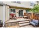 Wooden back deck with brick accents, outdoor seating, and access to the residence at 9672 W Chatfield Ave # C, Littleton, CO 80128