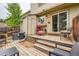 Cozy back deck features weathered wood, patio furniture, a sliding glass door, and exterior access at 9672 W Chatfield Ave # C, Littleton, CO 80128