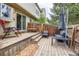 Wooden back deck is complete with brick accents, an umbrella, and outdoor seating at 9672 W Chatfield Ave # C, Littleton, CO 80128