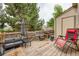 Backyard wooden deck with a grill, seating, and string lights at 9672 W Chatfield Ave # C, Littleton, CO 80128