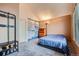 Cozy bedroom with vaulted ceiling, plush carpet, light walls and large map decor at 9672 W Chatfield Ave # C, Littleton, CO 80128