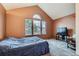 Vaulted ceiling bedroom with an arched window with natural light exposure, and bed at 9672 W Chatfield Ave # C, Littleton, CO 80128