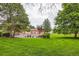 A lush green lawn surrounds the community pool, complete with lounge chairs and shade at 9672 W Chatfield Ave # C, Littleton, CO 80128