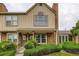 Charming townhouse with brick accents, well-maintained landscaping, and covered front entry at 9672 W Chatfield Ave # C, Littleton, CO 80128