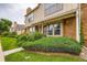 Two-story townhouse is complete with brick facade, well-manicured shrubs, and a front lawn at 9672 W Chatfield Ave # C, Littleton, CO 80128