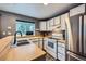 Bright kitchen featuring butcher block countertops, stainless steel refrigerator, and garden window at 9672 W Chatfield Ave # C, Littleton, CO 80128