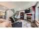 Cozy living room featuring a modern fireplace, mounted TV, and staircase access at 9672 W Chatfield Ave # C, Littleton, CO 80128