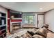 Modern living room with stone fireplace, large windows, and gray walls for a relaxing ambiance at 9672 W Chatfield Ave # C, Littleton, CO 80128