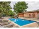 Community pool with lounge chairs and lush landscaping, perfect for relaxation at 9672 W Chatfield Ave # C, Littleton, CO 80128