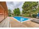 Beautiful pool area with lounge chairs, pergola and lush landscaping for relaxation and leisure at 9672 W Chatfield Ave # C, Littleton, CO 80128