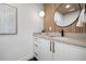 Stylish bathroom featuring a modern vanity, wood slat wall, and a round mirror at 1024 5Th St, Golden, CO 80403