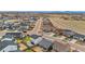 A wide aerial view of a suburban neighborhood with many single Gathering homes and green lawns at 114 S Edge Cliff St, Castle Rock, CO 80104