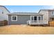 View of a backyard with a deck and neutral-toned siding at 114 S Edge Cliff St, Castle Rock, CO 80104