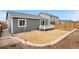 Wide view of fenced backyard with deck and gravel area at 114 S Edge Cliff St, Castle Rock, CO 80104