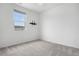 Sun-lit bedroom featuring a large window and cozy neutral carpet at 114 S Edge Cliff St, Castle Rock, CO 80104
