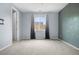 Well lit bedroom featuring neutral walls, carpeted floors, and a window overlooking the backyard at 114 S Edge Cliff St, Castle Rock, CO 80104