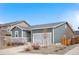 Single-Gathering home with a two-car garage, set against a clear blue sky at 114 S Edge Cliff St, Castle Rock, CO 80104