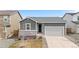 Charming single-story home with a gray exterior, stone accents, and a well-maintained front yard at 114 S Edge Cliff St, Castle Rock, CO 80104