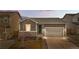 Charming single-story home with a gray exterior, stone accents, and a well-maintained front yard at 114 S Edge Cliff St, Castle Rock, CO 80104