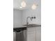 Kitchen island with stainless steel sink, dishwasher, and pendant lighting above at 114 S Edge Cliff St, Castle Rock, CO 80104
