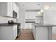 Modern kitchen with stainless steel appliances, white cabinetry, and a functional center island at 114 S Edge Cliff St, Castle Rock, CO 80104