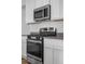 Close up of stainless steel stove and microwave in updated kitchen with ample cabinet space at 114 S Edge Cliff St, Castle Rock, CO 80104