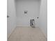 Laundry room with utility hookups and neutral tile flooring at 114 S Edge Cliff St, Castle Rock, CO 80104
