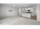 Bright living room flows into kitchen with stainless appliances and island, creating an open layout at 114 S Edge Cliff St, Castle Rock, CO 80104