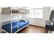Cozy bedroom features a bunk bed and ample natural light at 1213 Jamaica St, Aurora, CO 80010