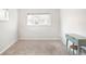 Bright bedroom features neutral carpet, white walls, and ample natural light at 1213 Jamaica St, Aurora, CO 80010