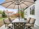 Back patio with shade umbrella, dining table, and outdoor seating at 1213 Jamaica St, Aurora, CO 80010