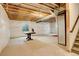Unfinished basement with exposed beams and a window for natural light at 4444 N Picadilly Ct, Aurora, CO 80019